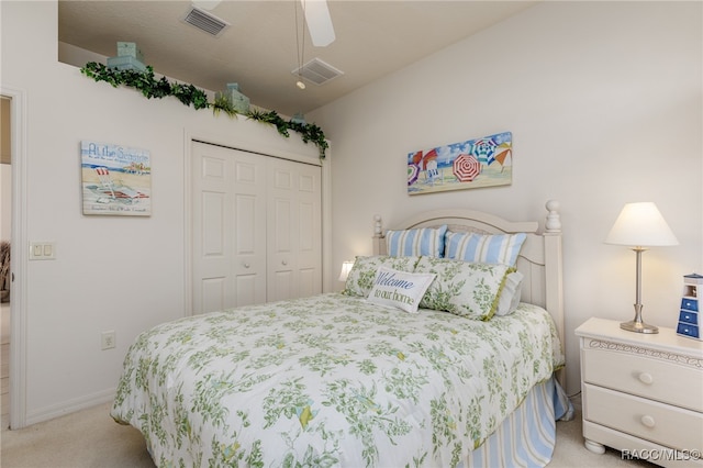 bedroom featuring light carpet, a closet, and ceiling fan