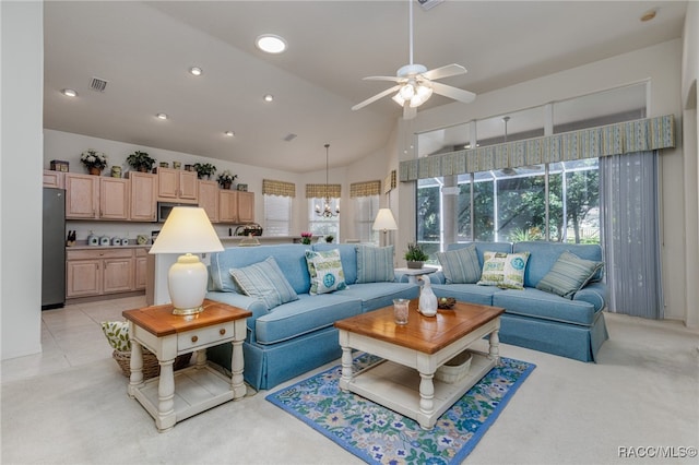 living room with light tile patterned floors, ceiling fan with notable chandelier, and lofted ceiling