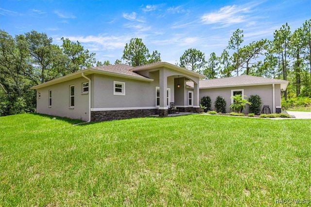 5352 W Corral Pl NW, Beverly Hills, FL 34465 - view of front of property featuring stucco siding, a front yard, and stone siding