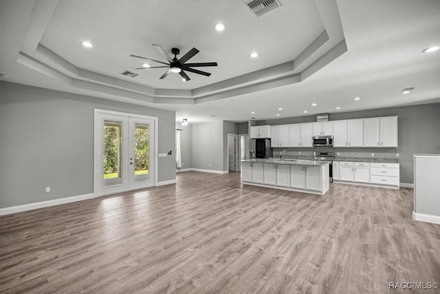 5352 W Corral Pl NW, Beverly Hills, FL 34465 - unfurnished living room with a raised ceiling, a ceiling fan, light wood-type flooring, recessed lighting, and french doors