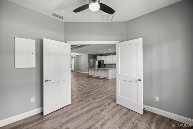 5352 W Corral Pl NW, Beverly Hills, FL 34465 - unfurnished living room with a ceiling fan, wood finished floors, and lofted ceiling
