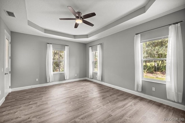 5352 W Corral Pl NW, Beverly Hills, FL 34465 - empty room with a raised ceiling, a ceiling fan, and wood finished floors