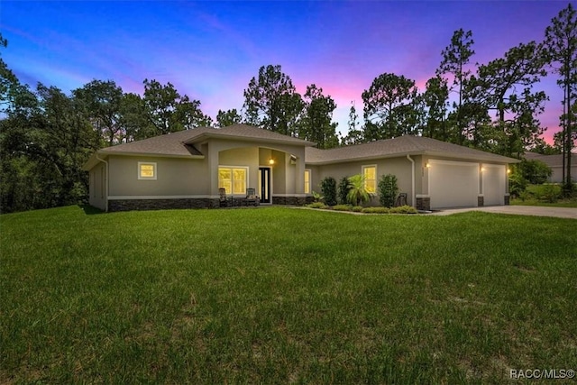 5352 W Corral Pl NW, Beverly Hills, FL 34465 - view of front of house featuring stucco siding, a front yard, a garage, and concrete driveway