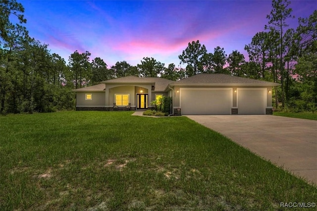 5352 W Corral Pl NW, Beverly Hills, FL 34465 - view of front of home with an attached garage, concrete driveway, stucco siding, and a front yard