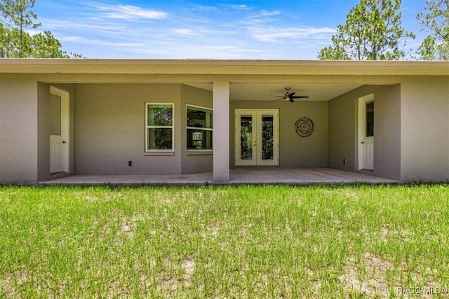 5352 W Corral Pl NW, Beverly Hills, FL 34465 - rear view of property with french doors, stucco siding, a yard, and ceiling fan