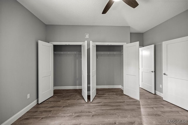 5352 W Corral Pl NW, Beverly Hills, FL 34465 - unfurnished bedroom featuring multiple closets, wood finished floors, and ceiling fan