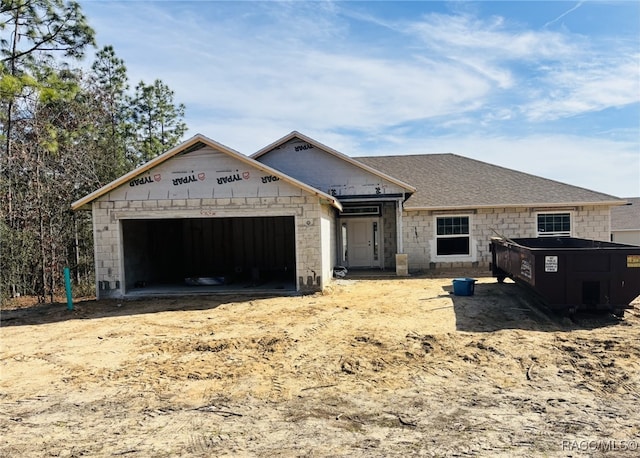 unfinished property featuring a garage