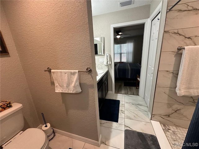 bathroom featuring vanity, toilet, and walk in shower