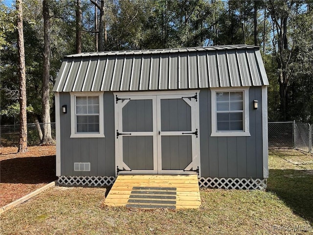 view of outbuilding featuring a lawn