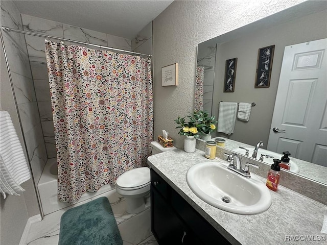 bathroom with vanity, toilet, and a textured ceiling