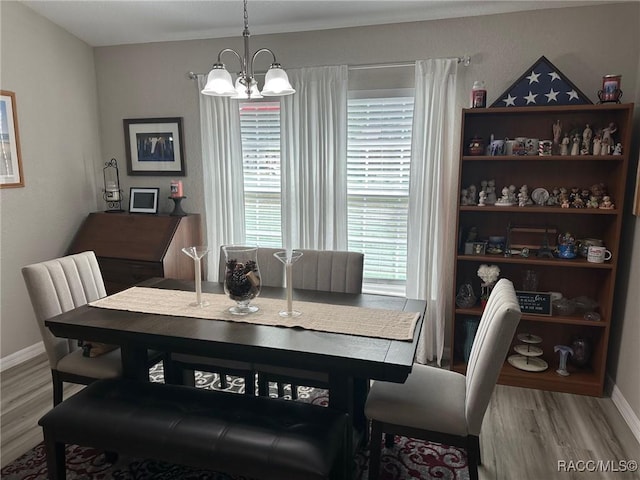 dining room with wood-type flooring and a chandelier