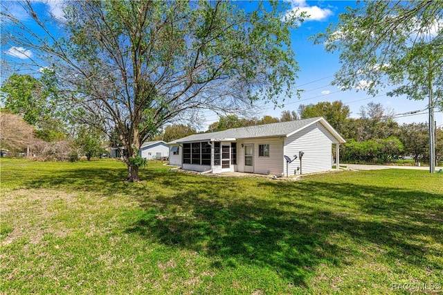 10780 SW 62nd Avenue Rd, Ocala, FL 34476 - rear view of house featuring a sunroom and a yard