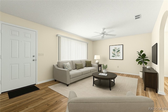 10780 SW 62nd Avenue Rd, Ocala, FL 34476 - living area with wood finished floors, baseboards, ceiling fan, and a textured ceiling