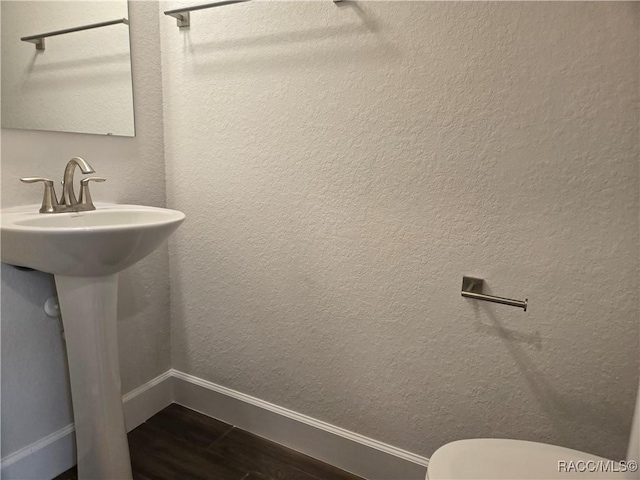 259 Bittern Loop, Inverness, FL 34453 - half bath with toilet, baseboards, and wood finished floors