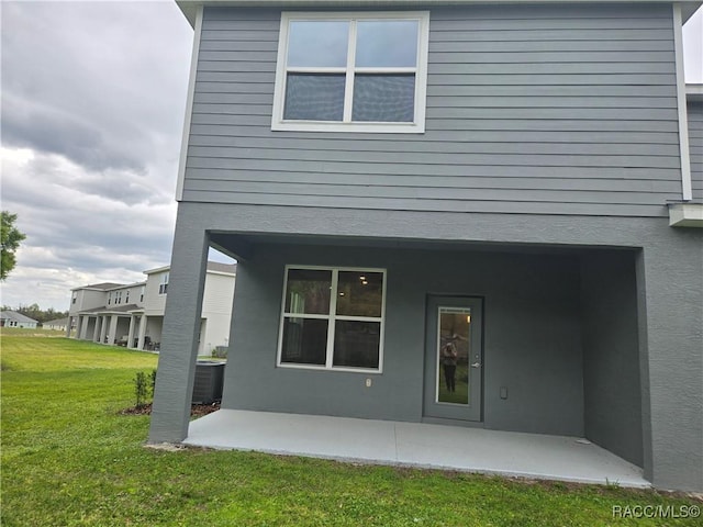 259 Bittern Loop, Inverness, FL 34453 - back of property featuring a patio area, central AC, and a yard