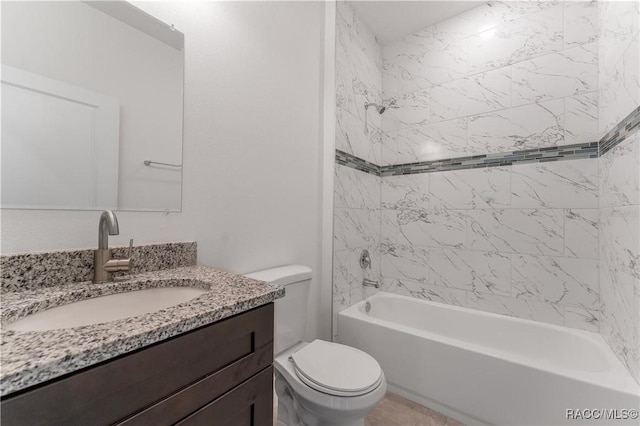 full bathroom with vanity, toilet, and tiled shower / bath