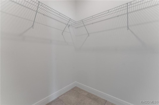 spacious closet with light tile patterned floors