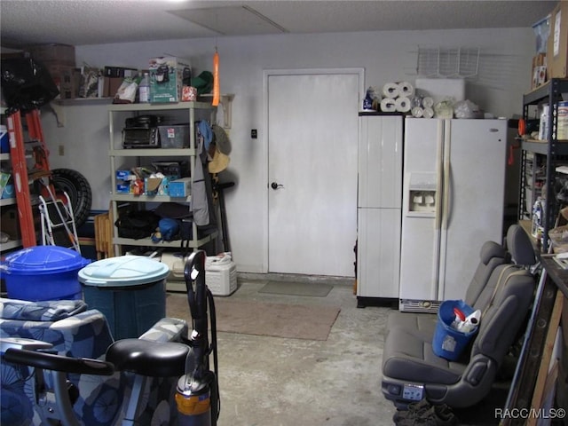 interior space with white refrigerator with ice dispenser