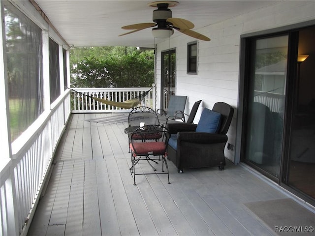 wooden deck with a ceiling fan