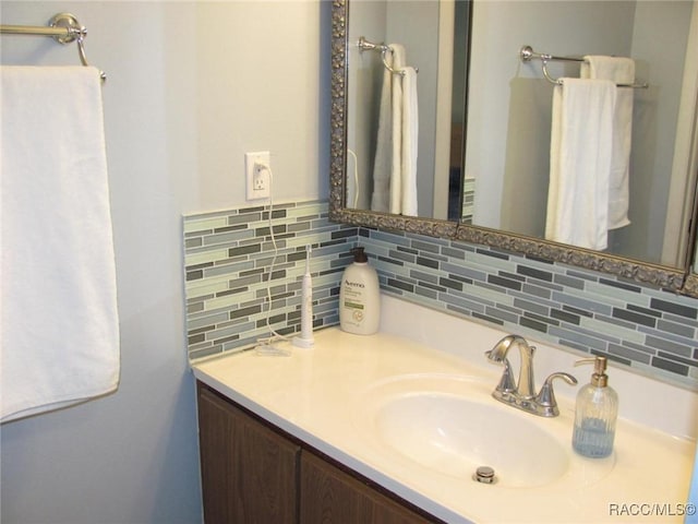 bathroom with vanity and decorative backsplash