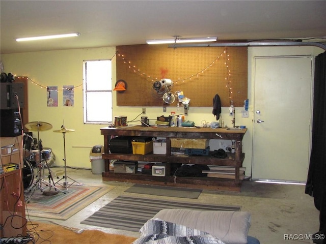 miscellaneous room featuring concrete flooring and a workshop area