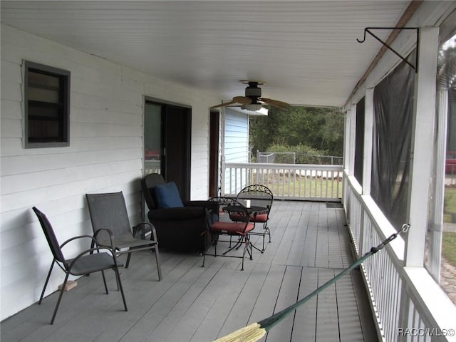 deck with a ceiling fan and a porch