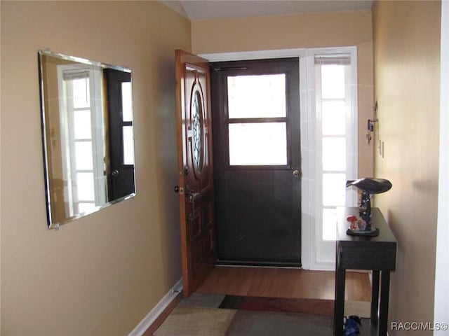 entryway with wood finished floors and baseboards