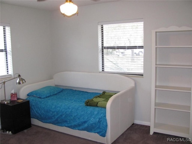 bedroom with dark colored carpet