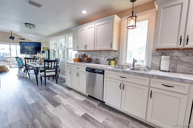 kitchen with white cabinetry, sink, ceiling fan, stainless steel dishwasher, and light hardwood / wood-style floors