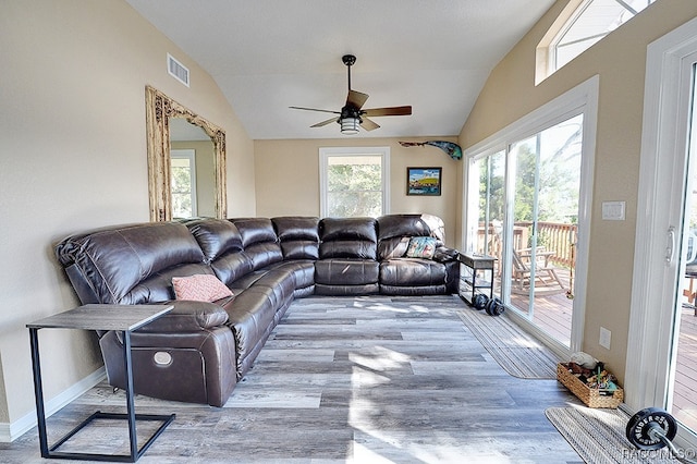 living room with vaulted ceiling, light hardwood / wood-style flooring, and ceiling fan