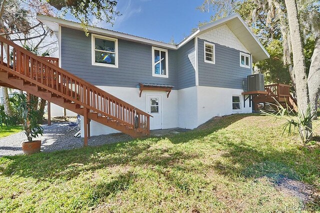 13920 W Evers Ct, Crystal River, FL 34429 - back of property featuring stairway, a wooden deck, and a yard