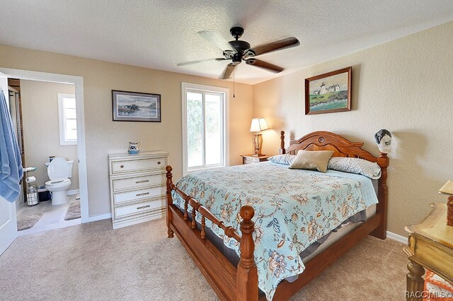 carpeted bedroom with ceiling fan, a textured ceiling, and connected bathroom