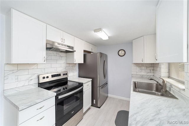 kitchen featuring light wood-type flooring, appliances with stainless steel finishes, white cabinets, and sink