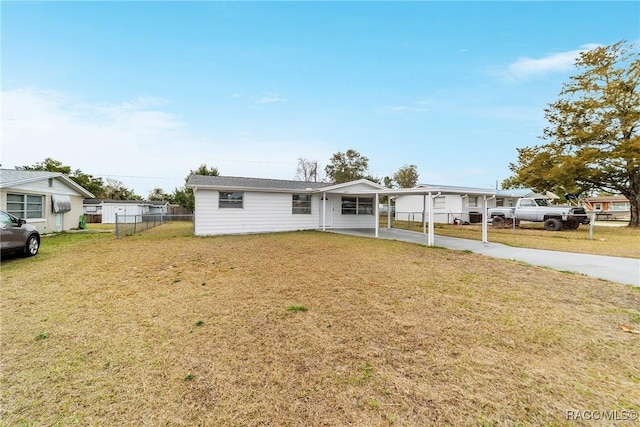 view of front of property with a front yard and a carport