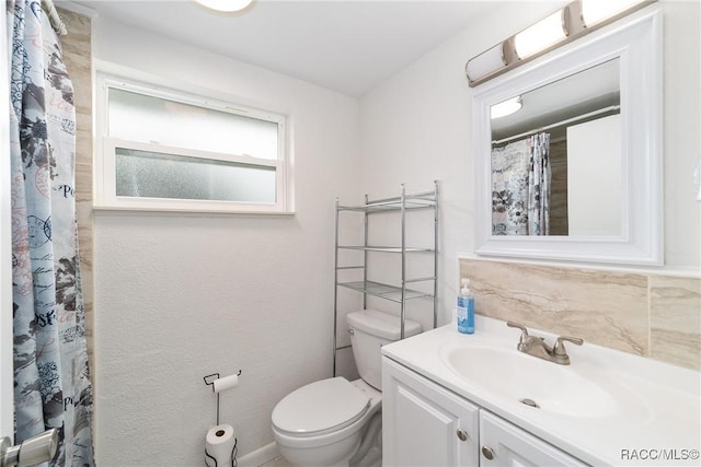 bathroom featuring toilet and vanity