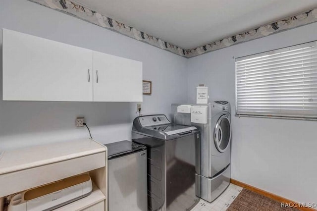 washroom featuring cabinets and separate washer and dryer