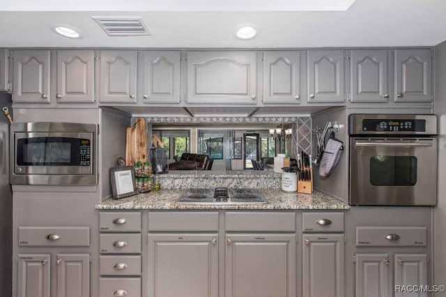 kitchen featuring appliances with stainless steel finishes and gray cabinets