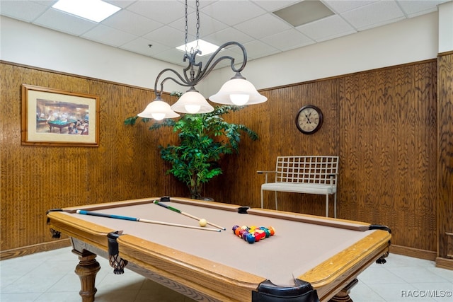 rec room featuring light tile patterned floors, billiards, a drop ceiling, and wood walls