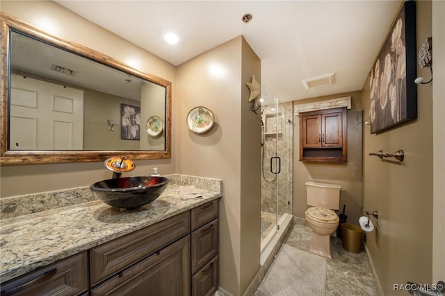 9950 S Ocean Dr Unit 302, Jensen Beach, FL 34957 - bathroom featuring toilet, vanity, a stall shower, and baseboards