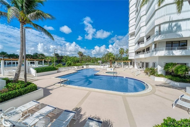 9950 S Ocean Dr Unit 302, Jensen Beach, FL 34957 - community pool with a patio and a community hot tub