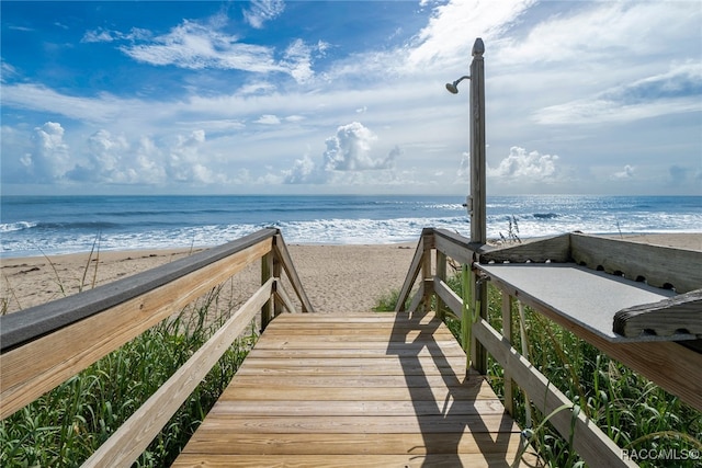 view of property's community featuring a water view and a view of the beach