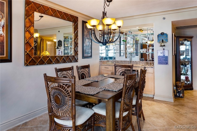 tiled dining space with a chandelier, a textured ceiling, and ornamental molding