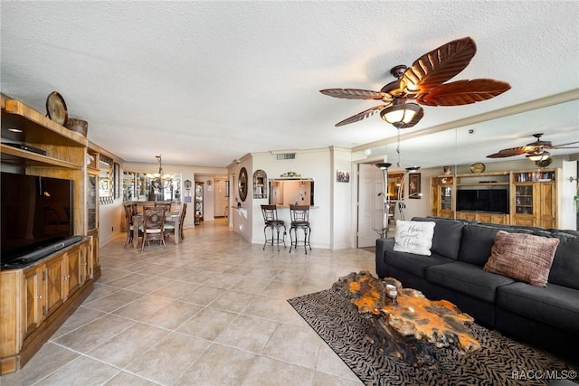 9950 S Ocean Dr Unit 302, Jensen Beach, FL 34957 - living room with a ceiling fan, light tile patterned floors, a textured ceiling, a chandelier, and arched walkways