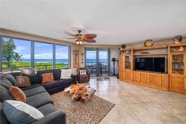 living room featuring light tile patterned floors, ceiling fan, and a textured ceiling