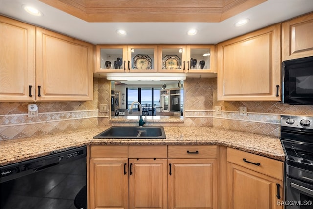 kitchen featuring backsplash, black appliances, a raised ceiling, crown molding, and sink