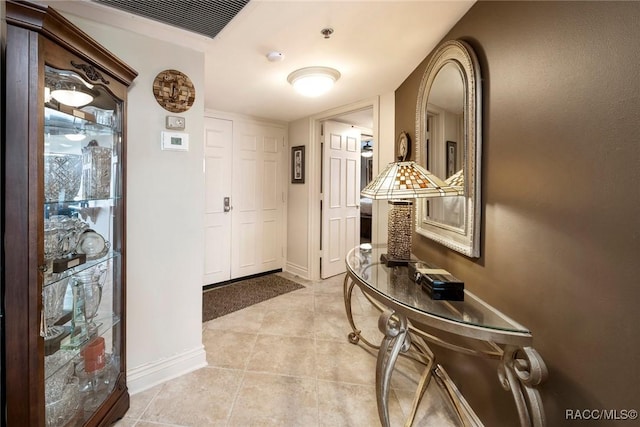 9950 S Ocean Dr Unit 302, Jensen Beach, FL 34957 - entrance foyer with light tile patterned flooring and baseboards