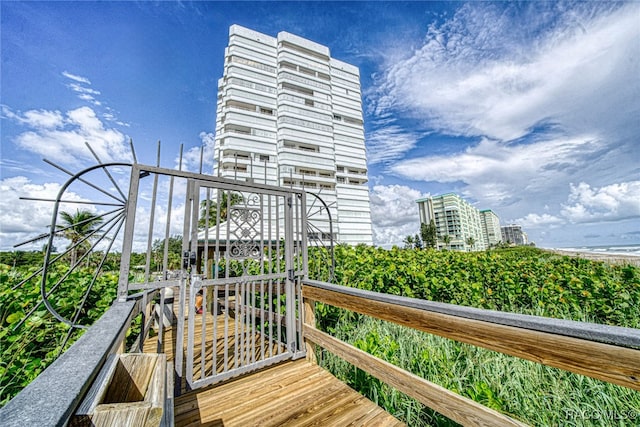 wooden terrace featuring a view of city and playground community