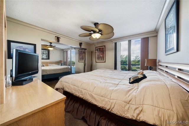 9950 S Ocean Dr Unit 302, Jensen Beach, FL 34957 - bedroom featuring ornamental molding and ceiling fan