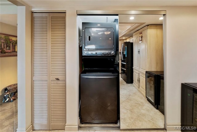9950 S Ocean Dr Unit 302, Jensen Beach, FL 34957 - kitchen with stacked washer / drying machine, wine cooler, freestanding refrigerator, recessed lighting, and light tile patterned flooring