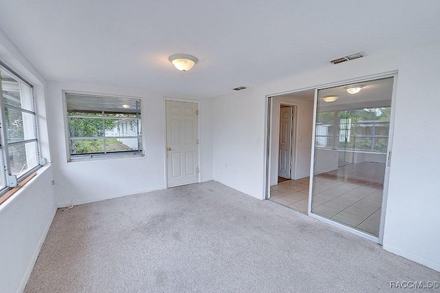 unfurnished bedroom featuring baseboards, visible vents, and carpet floors